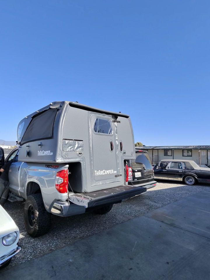 Rear three-quarter view of the truck and camper